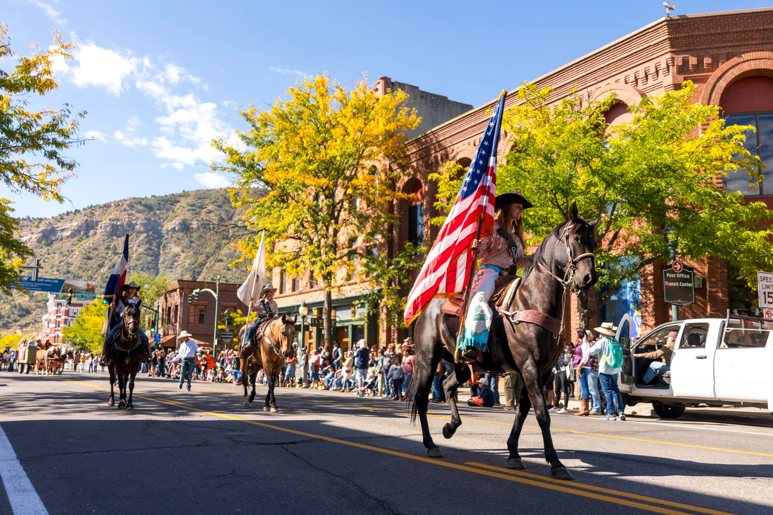 Horse riders carrying flags during a parade in downtown Durango, Colorado