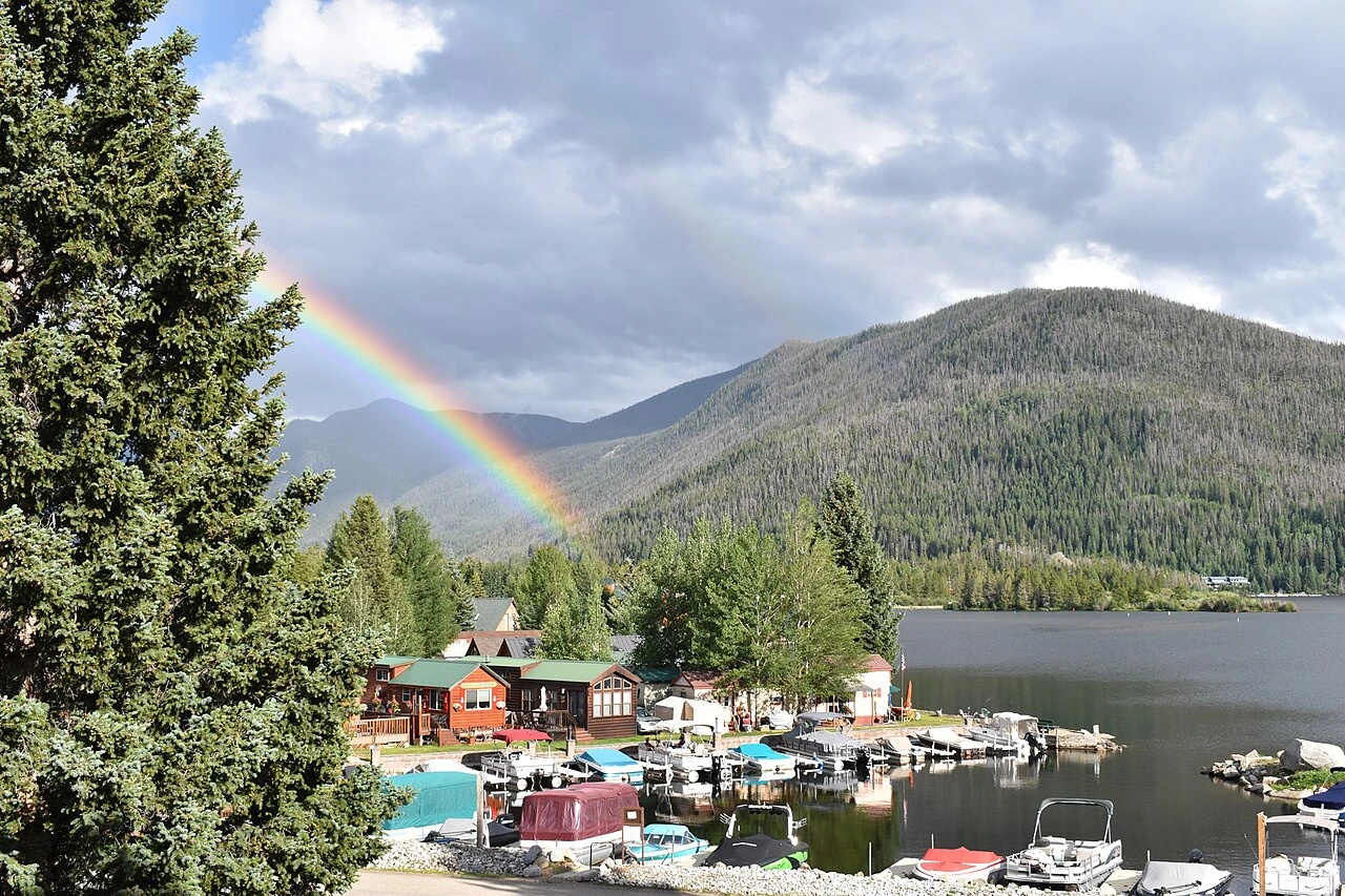 A rainbow above the marina and mountain shoreline at Grand Lake, Colorado